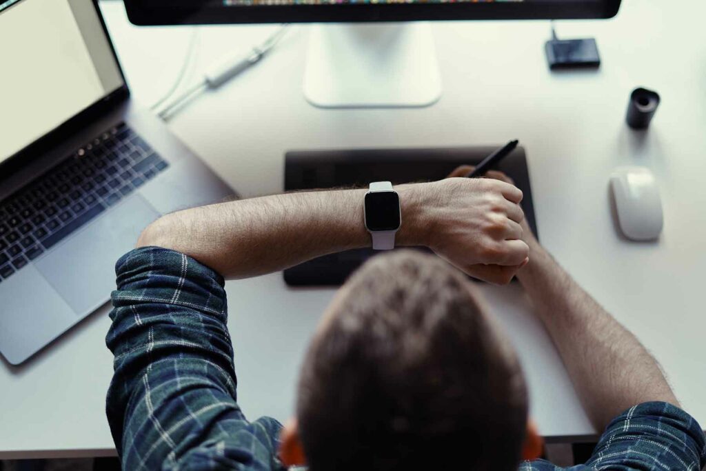 man-watching-smart-watch-while-working-ZKPYF4Q.jpg